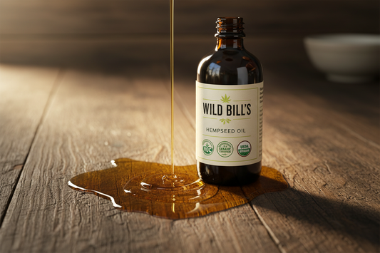 brand: wild bill's, product: regenerative organic certified (ROC) and USDA organic certified hempseed oil. no hemp leaves in image, have oil drizzeld on counter